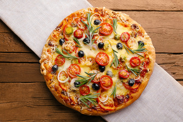 Delicious fresh pizza on wooden table top view