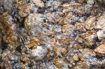 Closed up of water flow with rock in a river.