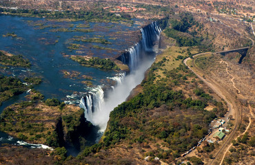 Fototapeta na wymiar The Victoria falls is the largest curtain of water in the world. The falls and the surrounding area is the Mosi-oa-Tunya National Parks and World Heritage Site (helicopter view) - Zambia, Zimbabwe