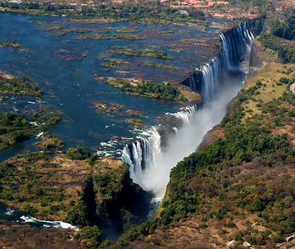 The Victoria falls is the largest curtain of water in the world. The falls and the surrounding area is the Mosi-oa-Tunya National Parks and World Heritage Site (helicopter view) - Zambia, Zimbabwe