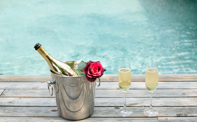 Champagne bottle in ice bucket and champagne glass by swimming p © bignai