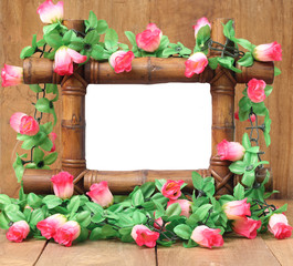 Bamboo frame with roses on a white background.