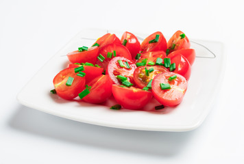 Cherry tomatoes decorated with green onions.
