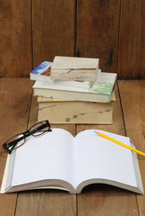 Notebooks, books, Temple eye, pencil on wood floors.