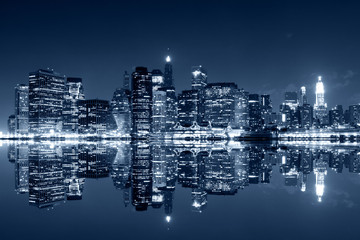 Manhattan at night with reflections on Harlem river