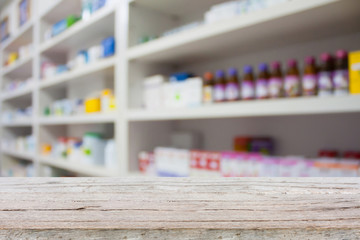 wood counter with blur shelves of drugs in the pharmacy