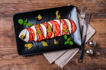 Caprese Salad on black plate