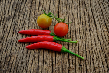 some chili peppers on a wood table