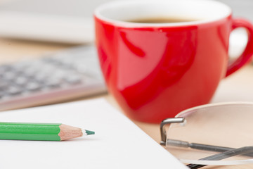 Coffee cup and laptop at office