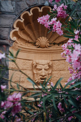 Architectural Detail of Fountain Tragic Mask in Oleander Flowers