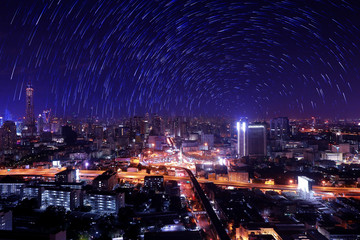 The night sky , the stars and the Tallest building in the city.