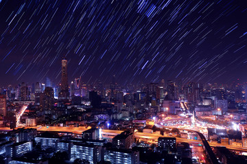 The night sky , the stars and the Tallest building in the city.