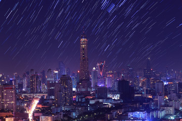 The night sky , the stars and the Tallest building in the city.