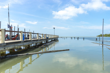 Fototapeta na wymiar Jetty with blue skies and reflection at Leka Beach (Pantai Leka) at Muar, Johore.