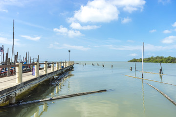 Jetty with blue skies and reflection at Leka Beach (Pantai Leka) at Muar, Johore.