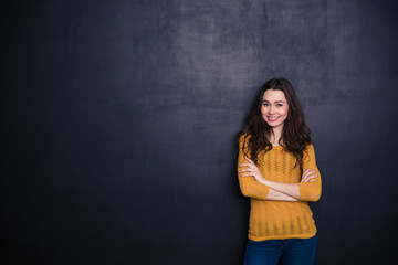 Smiling casual woman standing with arms folded