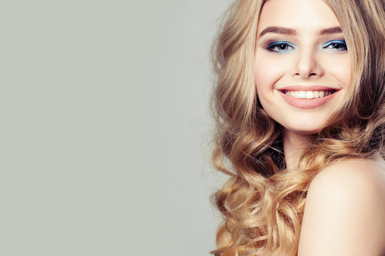 Smiling Woman Fashion Model with Blond Curly Hair on Background
