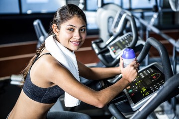 Smiling fit woman looking at camera at gym