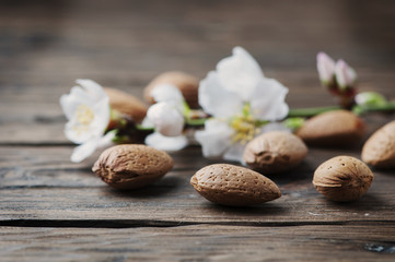 Fototapeta na wymiar Fresh almond and flowers on the wooden table