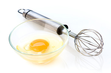 beaten egg in bowl and hand mixer