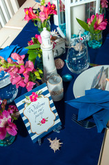 Festive table setting with starfishes, napkins, glasses and candles, bright summer table decor