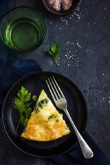 frittata (omelette) with vegetables and cheese in cast iron pan