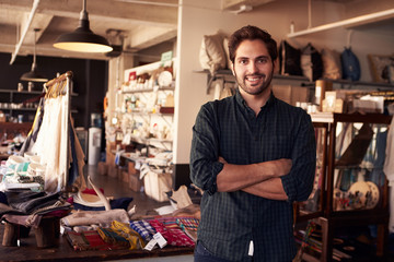 Fototapeta na wymiar Portrait Of Male Owner Standing In Gift Store