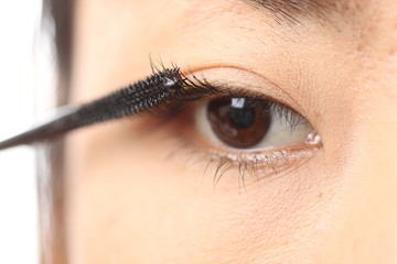 Mascara woman putting makeup on eyes.in studio