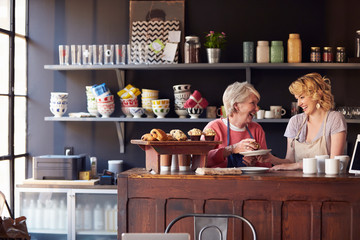 Staff At Coffee Shop Standing Behind Counter