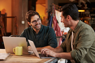 Male Fashion Designers In Meeting Using Laptop