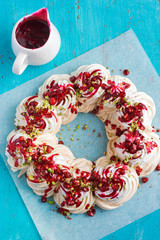 meringues pavlova cake wreath with pomegranate, cranberry and pi