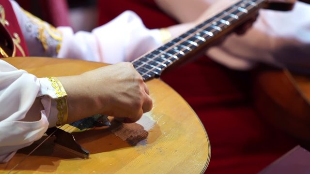 Musician's arm tuning musical instruments