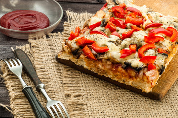 Piece of pizza on wooden table, selective focus.