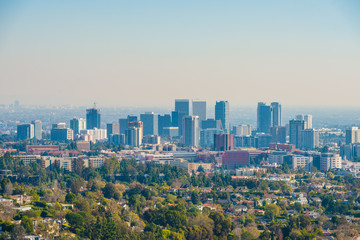 Naklejka premium Downtown Los Angeles skyline over blue cloudy sky