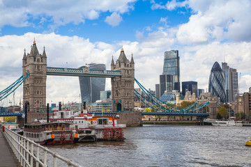 Fototapeta na wymiar LONDON, UK - APRIL 30, 2015: Tower bridge and City of London financial aria on the background. View includes Gherkin and other buildings