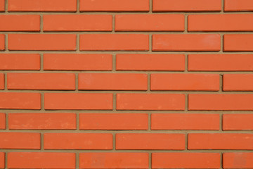 стена кирпичная красная, ровные швы.