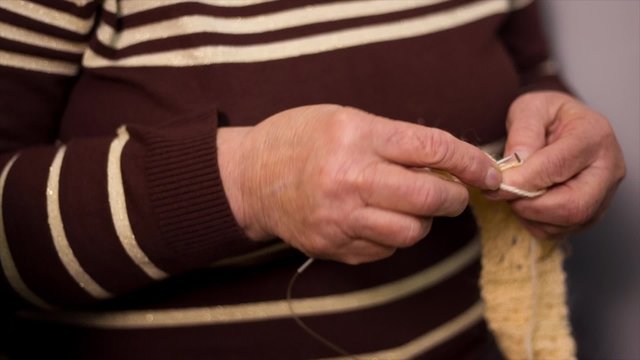 Grandmother knits a sweater