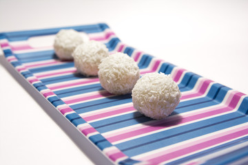 white chocolate balls with coconut - isolated on white background