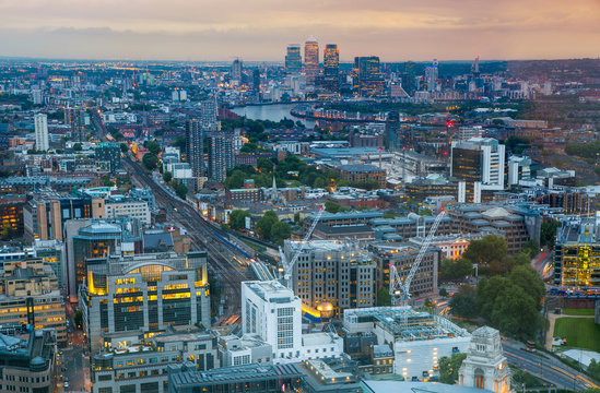 London at sunset, aerial view includes famous buildings, streets and Canary Wharf aria at distance 