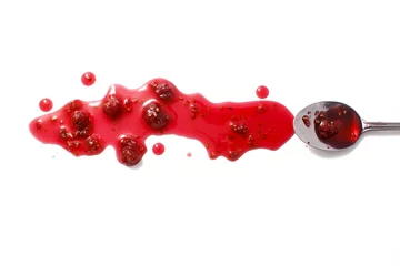 Foto op Plexiglas splashes of raspberry jam and a spoon with crimson jam. raspberry jam and raspberries isolated on white background. flat lay, top view © EvgeniiAnd