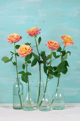 Pink roses in glass bottles