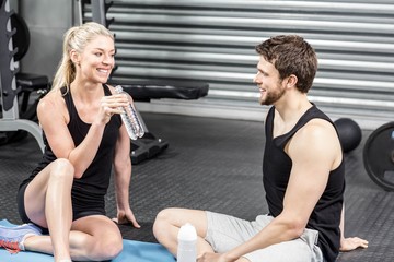 Fototapeta premium Couple sitting on fitness mat