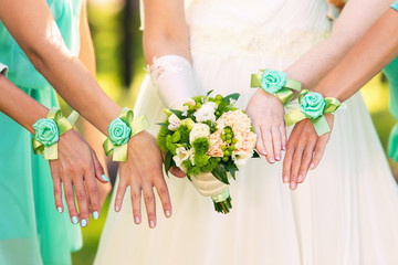 bride and her bridesmaids  with bracelets on hands