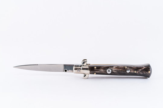 Italian switchblade knife, horizontal position white background. 