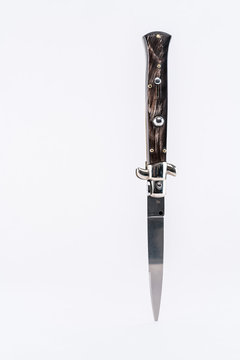 Italian switchblade knife vertical position, white background.