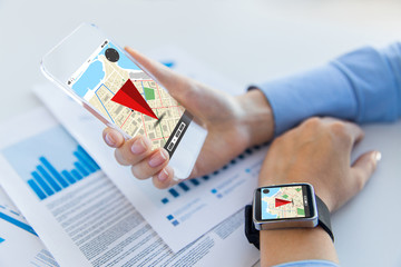 hands with navigator map on smart phone and watch