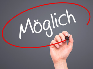 Man Hand writing Moglich (Possible in German) with black marker