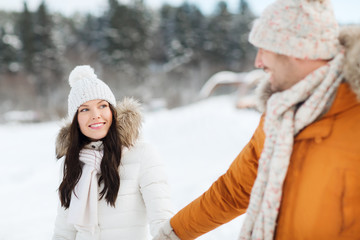 happy couple walking over winter background