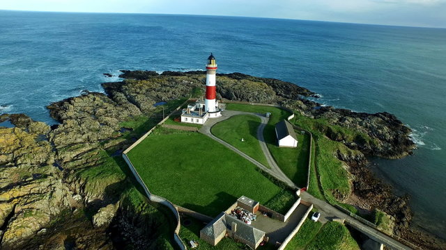 Aerial shot of Boddam lighhouse off the coast of Aberdeen, Scotland
