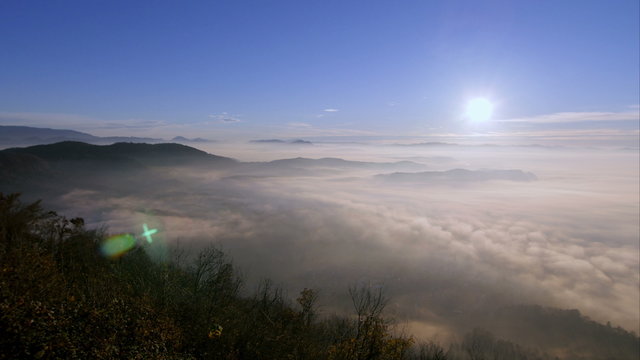 Morning mountain panorama with fog on the valley